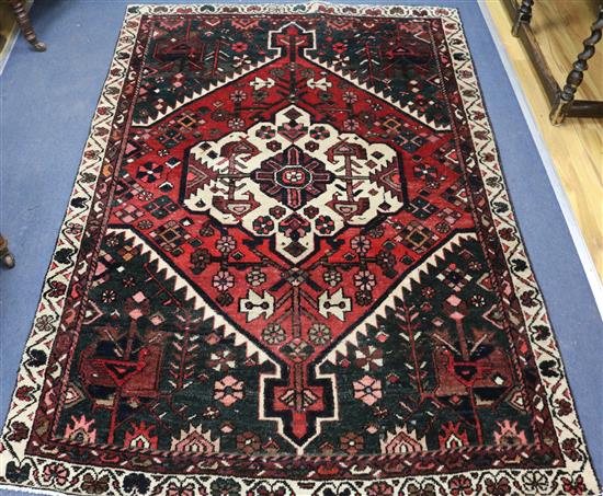 A Persian red ground carpet 200 x 143cm